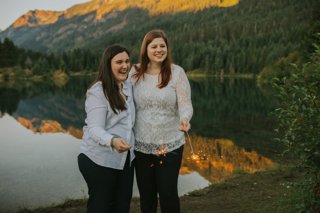 Queer couple eloping in Washington State celebrating with sparklers