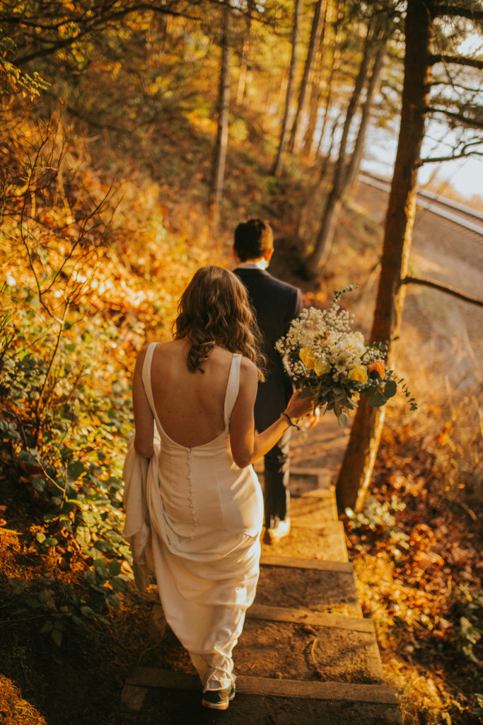 bride and groom walking down a trail in Washington
